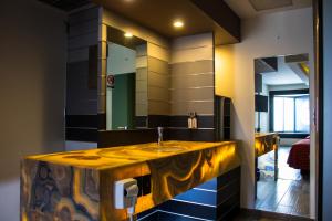 a bathroom with a sink and a large mirror at HOTEL MIRAMAR in Mexico City