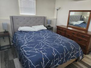 a bedroom with a bed and a large mirror at Modern Cozy two bedroom apartment with off-street Parking in Worcester