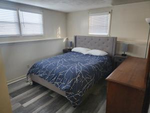 a bedroom with a bed with two pillows on it at Modern Cozy two bedroom apartment with off-street Parking in Worcester