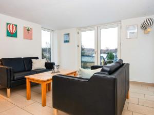 a living room with two couches and a table at 10 person holiday home in Glesborg in Bønnerup