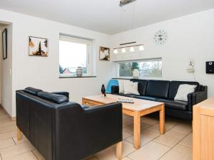 a living room with a couch and a table at 10 person holiday home in Glesborg in Bønnerup