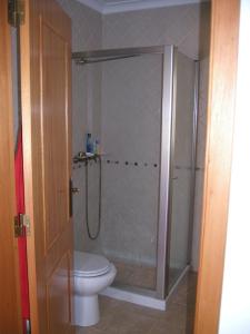 a bathroom with a shower and a toilet at Casa da Carrasqueira - Sesimbra in Sesimbra