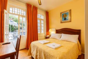 Un pat sau paturi într-o cameră la Hotel Casa Gonzalez