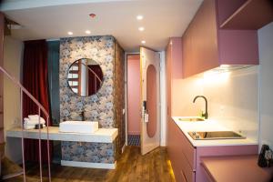 a bathroom with a sink and a mirror at Grace Chapinero in Bogotá