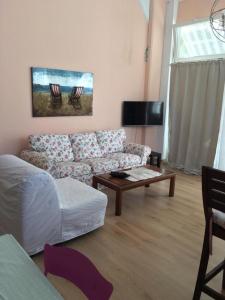 a living room with a couch and a coffee table at Aphrodite Suites in Kini