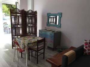 a dining room with a table and a dresser and a mirror at Aphrodite Suites in Kini +5 photos