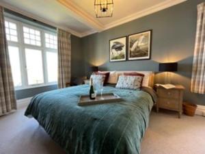 a bedroom with a large bed with a table on it at Folly 1, Port Isaac Bay Holidays in Port Isaac