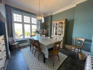 a dining room with a table and chairs at Folly 1, Port Isaac Bay Holidays in Port Isaac