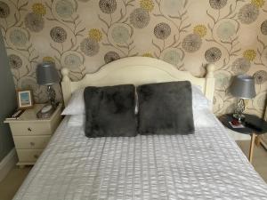 a bed with a black pillow on it in a bedroom at Park View in Chester +14 photos