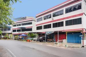 a street view of a building on the side of a street at SPOT ON 92053 Bagus Stay in Tanjung Pinang 