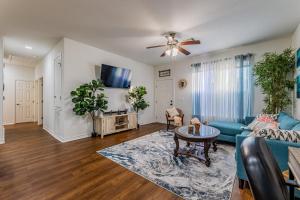 a living room with a blue couch and a table at Little Blue House on Lonnie Lane in Houston