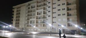 a building at night with two people walking in front at Cozy place in Trebinje