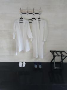 a group of white clothes and shoes on a wall at Dolce Ouidah Lodge in Ouidah