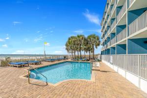 a swimming pool in front of a building at Sugar Sands Beachfront Hotel, a By The Sea Resort in Panama City Beach