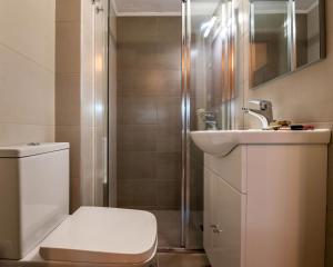 a bathroom with a toilet and a sink and a shower at COZY STUDIO in RETHYMNO TOWN in Rethymno