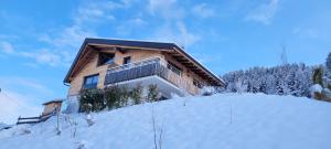 a house on top of a snow covered hill at Gschwendtalm Tirol - Luxus-Apartment für Ihre Auszeit in Tulfes