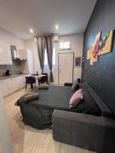 a bedroom with a large bed and a table at Casa Beda in Bologna