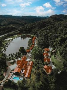 an aerial view of a resort with a lake and trees at Natureza Eco Lodge in Vargem Alta