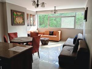 a living room with a couch and a table at Apartments Puerto Santa Ana in Guayaquil