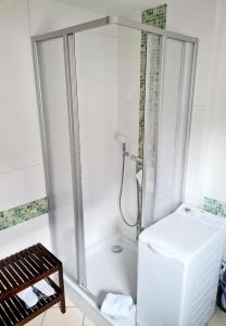 a bathroom with a shower and a white refrigerator at Ferienhaus Grüner Bungalow Kontaktloser CheckIn in Stendell +44 photos