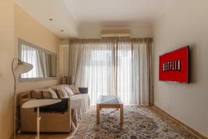 a living room with a couch and a table at Piraeus Seaview Appartment in Piraeus