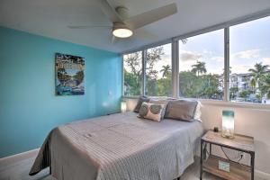 a bedroom with a bed and a large window at Canal-Front Condo Walk to Downtown Ft Lauderdale! in Fort Lauderdale