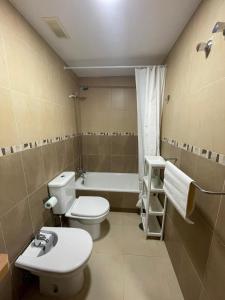 a bathroom with a toilet and a sink and a bath tub at Apartamento Murcia in Murcia