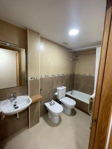 a bathroom with a sink and a toilet and a tub at Apartamento Murcia in Murcia