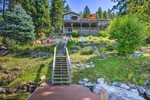 a house with a staircase leading up to a house at Lake Pend Oreille Waterfront with Amazing Views in Sagle