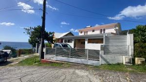 una casa con una puerta al costado de una carretera en Appartement vue mer Chez Ti Louis - Grande Anse, en Les Anses-dʼArlet