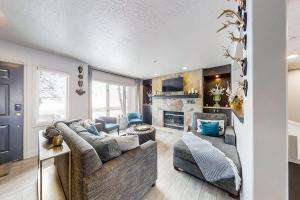 a living room with a couch and a fireplace at Wildflower Unit 8 in Park City