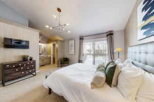 a bedroom with a large white bed and a window at Wildflower Unit 8 in Park City