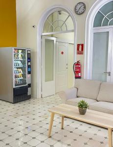 a living room with a couch and a refrigerator at Hostel Friends Barcelona in Barcelona