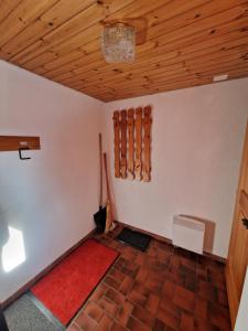a room with a wooden ceiling and a red rug at Bettmeralp Chalet Zendorn in Bettmeralp +54 photos