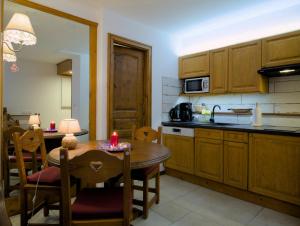 a kitchen with a table with a candle on it at Happy Moose - Cosy Mont Blanc View apartment in Chamonix-Mont-Blanc