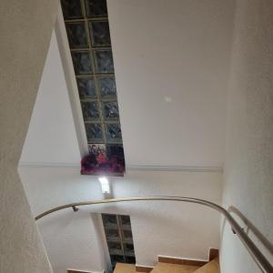 a stairwell with a glass window in a building at La Simo in Sinaia