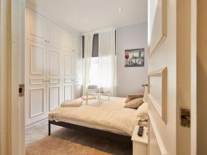 a bedroom with a large bed with a window at (Oxford Street - Piccadilly Circus) Apartment Central London in London