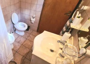 ein Badezimmer mit Waschbecken und Toilette in der Unterkunft La Calma Casa de Campo - Villa Parque Siquiman in Villa Parque Siquiman + 32 Fotos