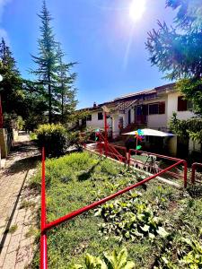a red fence in front of a house at Casa serenaurora in Castel di Sangro