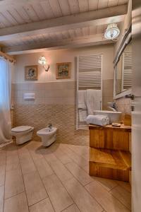 a bathroom with a toilet and a sink and a tub at BnB Borgo le Vigne - Il Mosto Only Adults in Tignale