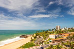 a view of a beach with palm trees and the ocean at Praia a Vista Salvador Hotel in Salvador