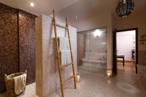 a bathroom with a towel ladder and a shower at Porto Kea Suites in Korissia
