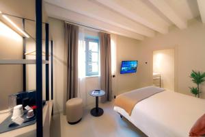 a hotel room with a bed and a window at Bergamo INN 21 in Bergamo
