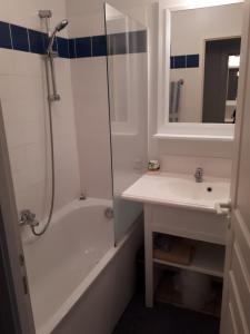 La salle de bains est pourvue d'une baignoire, d'un lavabo et d'une douche. dans l'établissement Appartement forever, à Les Sables-dʼOlonne