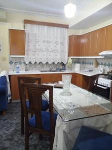 a kitchen with a table and some chairs and a table and a counter at Robert House in Samos