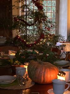 a table with a pumpkin and a christmas tree at Chateau Paysan ecolobio de Durianne in Le Monteil