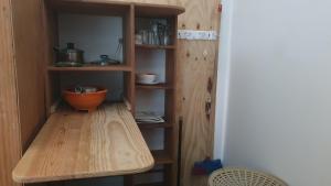 a wooden shelf with an orange bowl on it at APARTO-STUDIO JUNTO AL MAR Blue Lizard Studio in Providencia