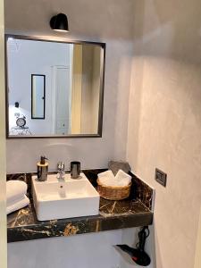 een badkamer met een wastafel en een spiegel bij Figurari Home Napoli-2 in Napels