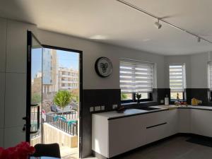 a kitchen with a large window with a view of a building at Luxurious sunlit maisonette with large terrace! in Marsaskala