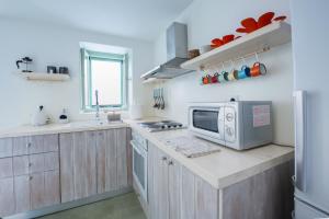 a kitchen with a microwave on a counter top at Stasa Aegina in Egina
